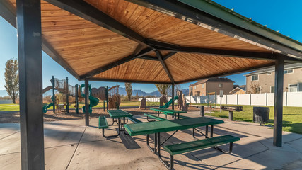 Panorama frame Empty green tables and benches in an urban park