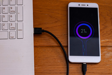 smartphone charging connected to a computer