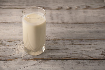 glass of milk on wooden table