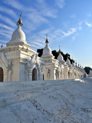 Fototapeta premium The pagoda of Kuthodaw Pagoda with wave of cloud in Mandalay, Myanamr