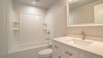 Fototapeta na wymiar Panorama Modern fitted white bathroom interior of home