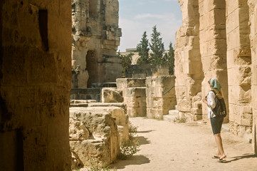A girl inspects the ruins of the Roman amphitheater in El Jem, a UNESCO World Heritage Site