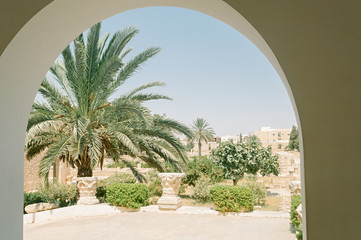 The Scenic garden with the capitals of the ancient columns in the courtyard of the archaeological museum of El Jem, Tunisia