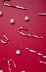 Naklejka premium Candies and white coconut candy balls on a red background. Christmas postcard. Happy New Year.