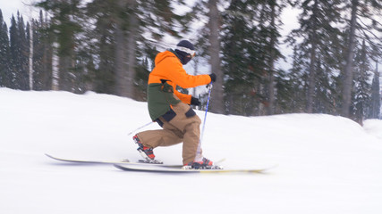 athlete skies along snowy track using technique of Telemark - obrazy, fototapety, plakaty