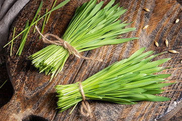 Fresh homegrown barley grass on a wooden table