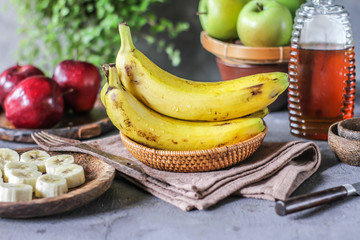 Photo of fresh raw banana bunch on table. Healthy food. Peeled cut bananas. Vegetables. Raw organic fruit. Slice. Photo.