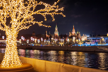 Moscow, Russia - January 03, 2020:   View of the Moscow Kremlin, Moscow river and Christmas decoration city at night.