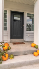 Vertical Halloween or autumn pumpkins on a house steps