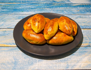 Pies with stewed cabbage and carrots baked in the oven