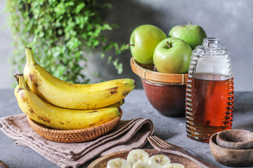 Photo of fresh raw banana bunch on table. Healthy food. Peeled cut bananas. Vegetables. Raw organic fruit. Slice. Photo.