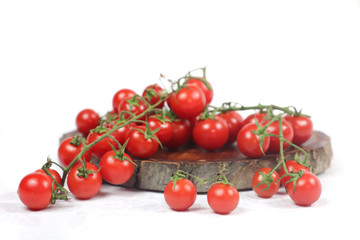 vine tomatoes on wooden cutting board with white background