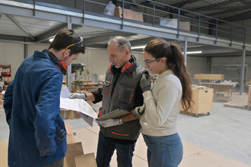 Young people in job training in carpentry workshop