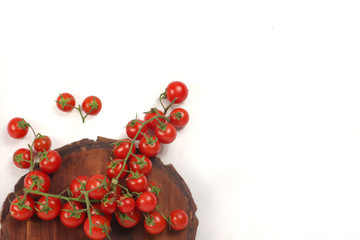vine tomatoes on wooden cutting board with white background