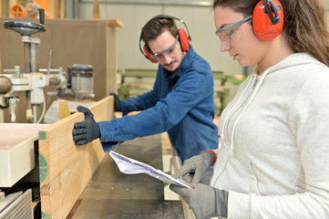 Students in carpentry doing a job training in workshop