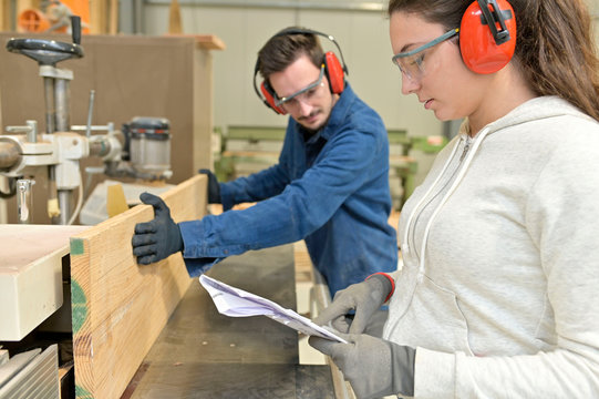 Students in carpentry doing a job training in workshop