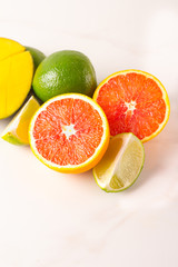 mango, lime and red orange on white