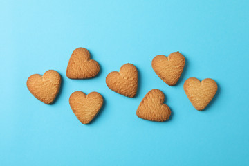 Heart shaped cookies on blue background, space for text