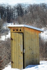 a wooden latrine near the forest