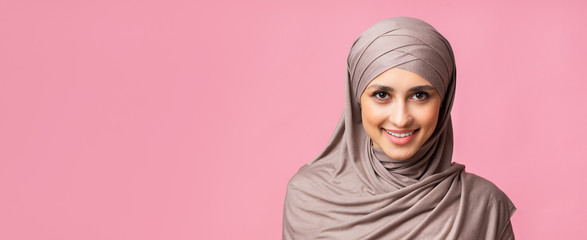 Portrait of confident arabic girl in headscarf looking at camera