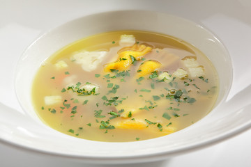 Chicken Bouillon with Tortellini Pasta in White Restaurant Bowl