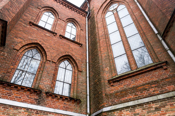 Fototapeta na wymiar Neogothic building with tall windows