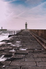 Obraz premium The pier to the Sunset Lighthouse. Lighthouse as a Ladmark. Foz do Douro. Porto. PortugalLighthouse as a Landmark