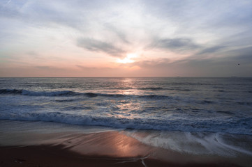 Orange sunset over the ocean, sun reflected in the water