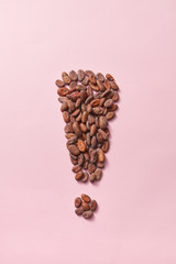 Natural cocoa beans in the form of exclamation mark.