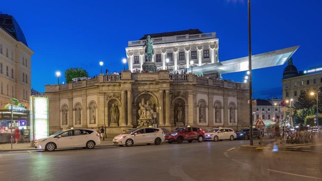 Night view of equestrian statue of Archduke Albert in front of the Albertina Museum day to night transition timelapse in Vienna, Austria. Illuminted buildings on a background