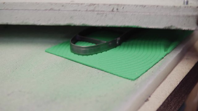 Cutting shoe insoles at the shoe factory.