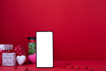 Copy space on Red Valentines background with Blank screen on smart phone.