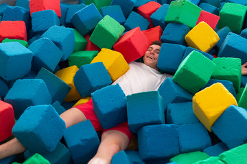 Fitness, fun, leisure and sport activity concept - Funny happy man having fun on a trampoline...