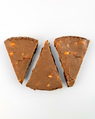 Pieces of snickers dessert on white background