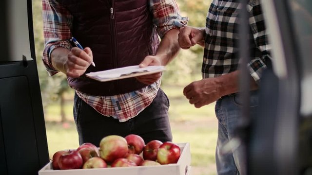 Handheld view of good deal between farmer and businessman