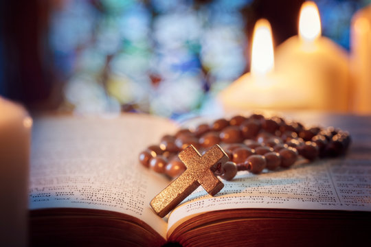 Rosary beads and crucifix cross on holy bible - Powered by Adobe