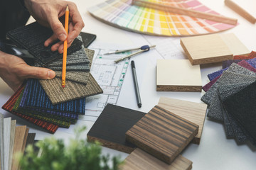 designer choosing flooring and furniture materials from samples for home interior design project - obrazy, fototapety, plakaty