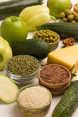 Set of healthy food: cheese leafy vegetables, beans nuts, quinoa bulgur, chickpeas, flax almond. Alkaline foods. Sources of omega 3.  Flat lay, top view.