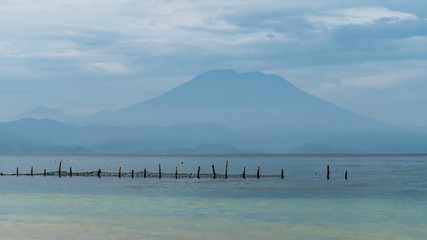 Beautifull evening view to St. Agung Vulcano on Bali from Nusa Penida Island, Net in front some Clouds in Background