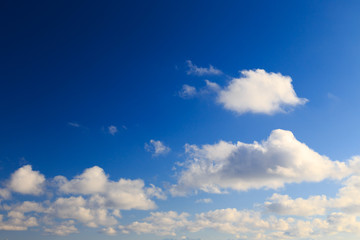 Bright cumulus clouds against the blue sky. Sunset sky Natural background. seascape