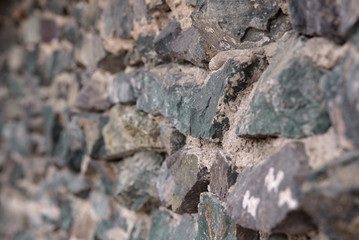Texture: a wall of folded natural stone, reinforced with a small amount of cement.