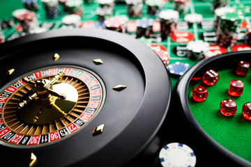 Casino concept. Gambling games - roulette and dice.  Chips on the roulette table with red and black numbers.