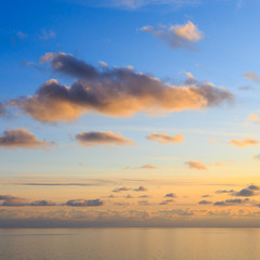 Fototapeta na wymiar Bright cumulus clouds against the blue sky. Sunset sky Natural background. seascape