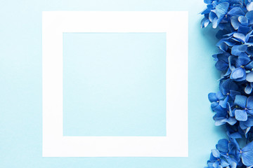 White frame and blue hydrangea flowers
