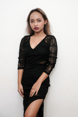 Young sexy girl wearing a black long lace dress, shot on isolated white background.