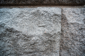 Texture of rough stone retro wall of gray granite