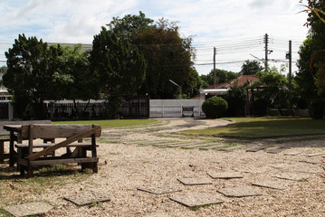 Stone cobbled walkway among the green lawns in the garden.