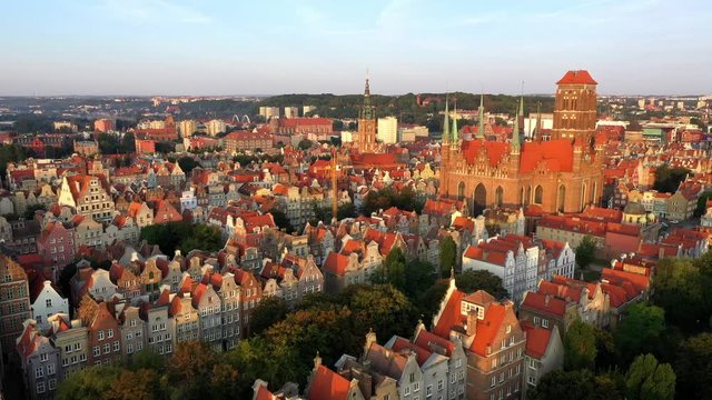 Gdansk, Poland. Aerial 4K reveal video of old city, Motlawa river and famous monuments: Gothic St Mary church, city hall tower,