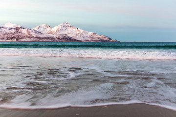 Amazing sunrise with amazing magenta color over sand beach. Tromso, Norway . Polar night. long shutter speed