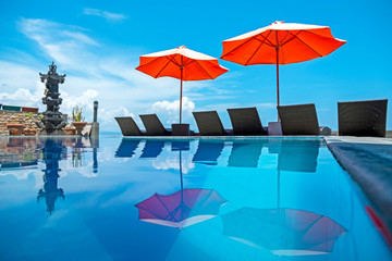 Umbrellas and beach chairs at the swimming pool on Bali Island Indonesia